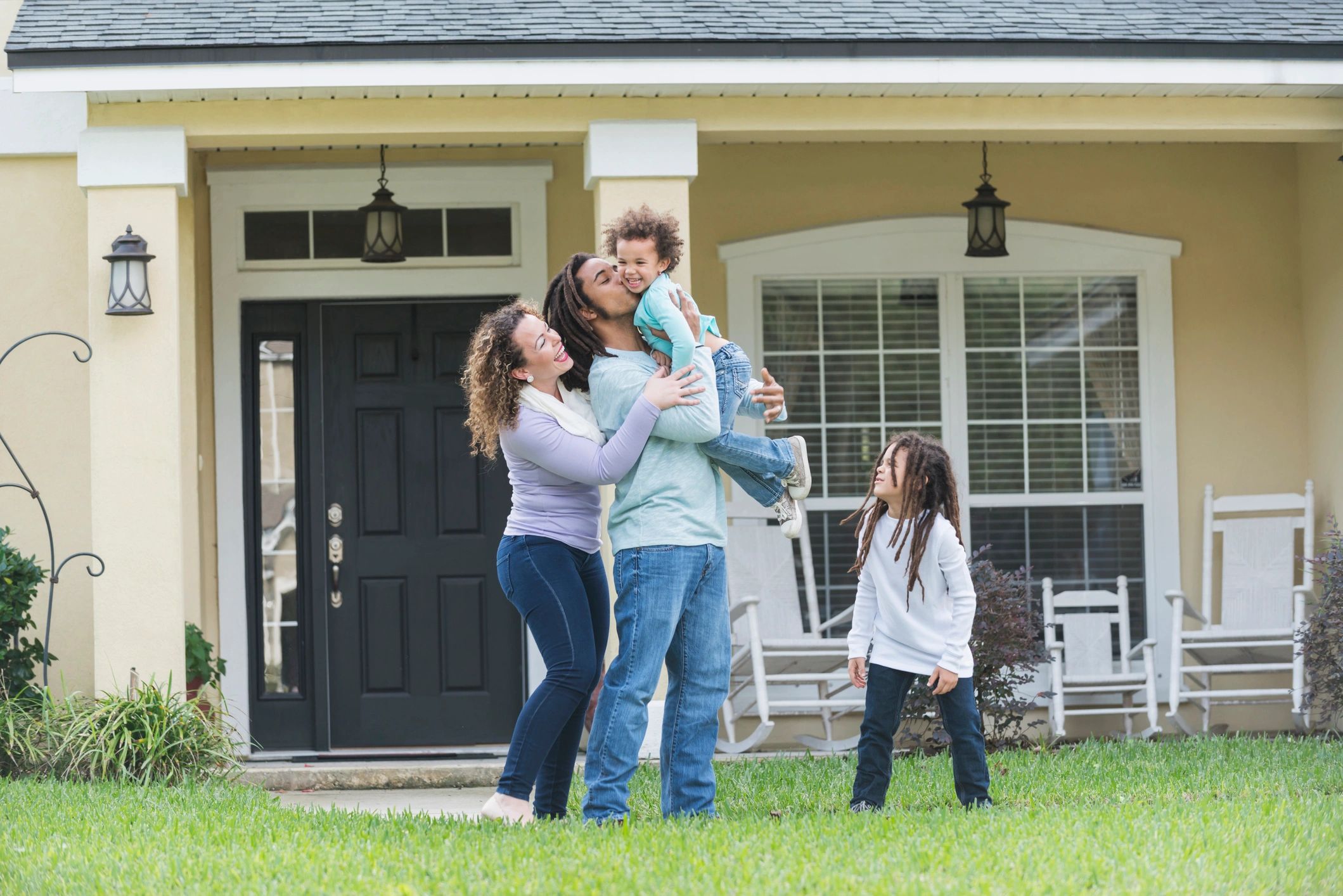 Happy family outside a home